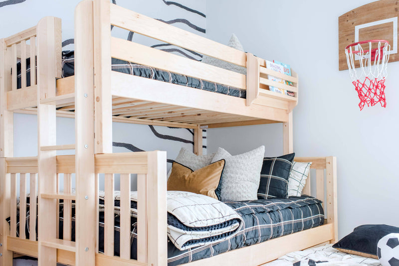 Light wood twin-over-twin bunk bed in kids bedroom with plaid bedding, ladder, built-in book shelf and indoor basketball hoop