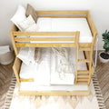 Natural wood bunk bed with pull-out trundle and ladder, white bedding and neutral pillows on patterned rug — space-saving kids' bedroom furniture