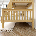 Twin-over-twin natural pine solid wood bunk bed with ladder and white bedding in a modern kids' bedroom on herringbone hardwood floor with fringed rug