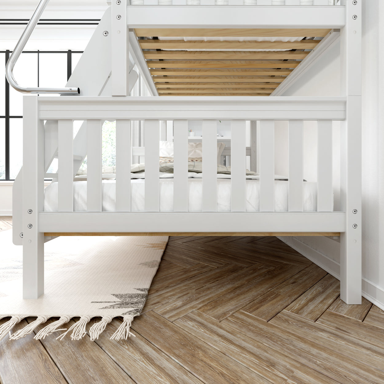 White wooden bunk bed with safety rails in modern bedroom on herringbone patterned wooden floor.