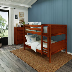 Wooden bunk bed in a cozy bedroom with blue accent wall and natural light.