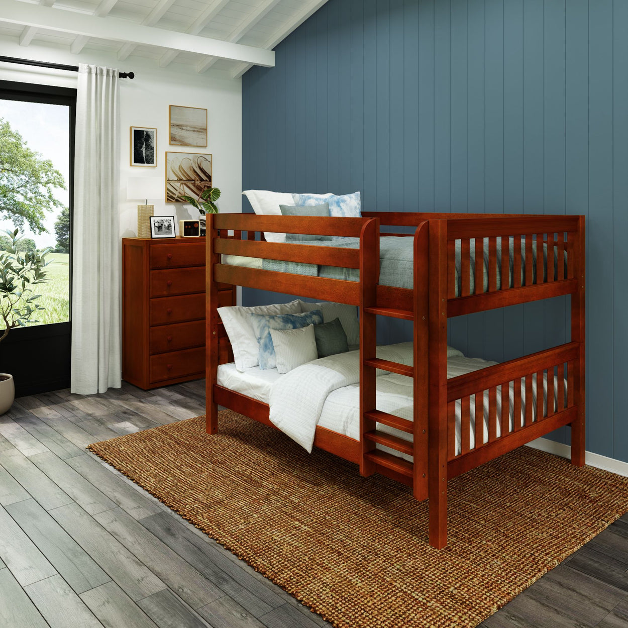 Rustic wooden bunk bed in a cozy bedroom with blue accent wall and natural light.