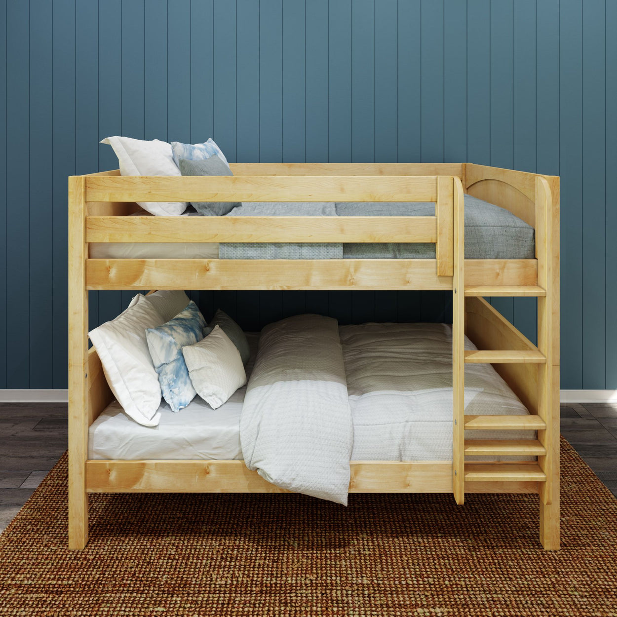 Wooden bunk bed with white bedding against a blue paneled wall.