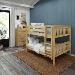 Wooden bunk bed in a cozy bedroom with blue accent wall and natural light.