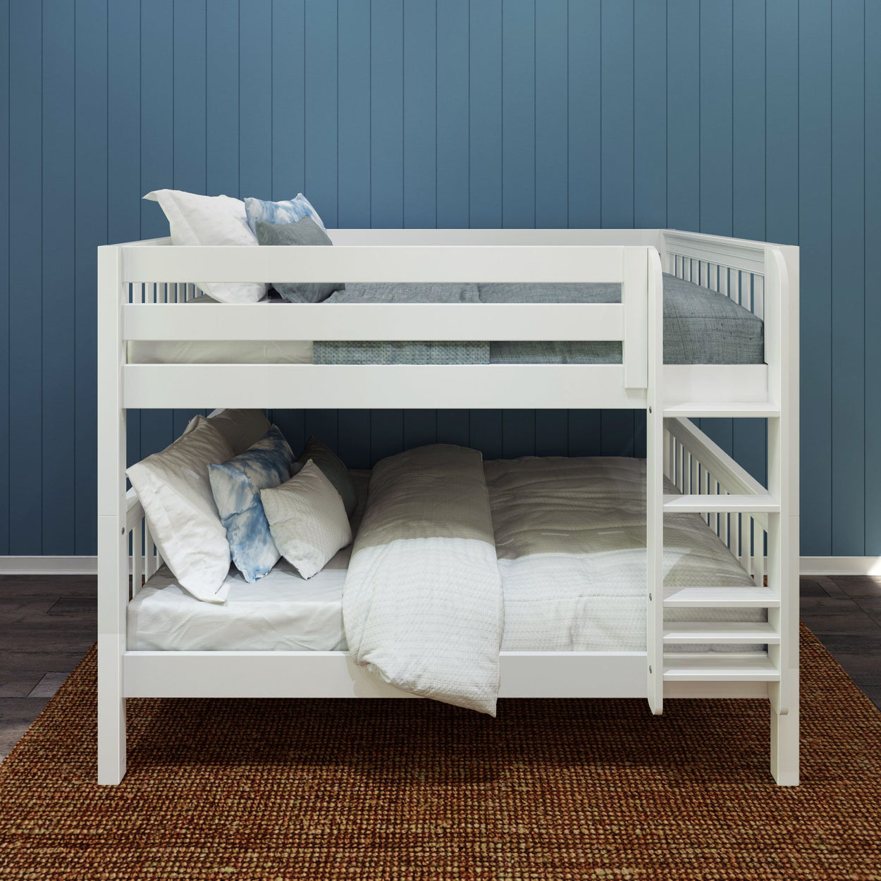 Stylish white bunk bed with comfortable bedding in a modern bedroom with blue paneled walls.