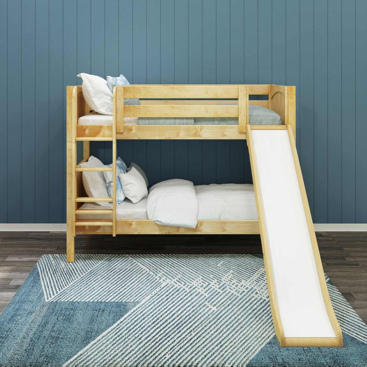 Wooden bunk bed with slide and ladder against a blue wall in a modern kids' bedroom.