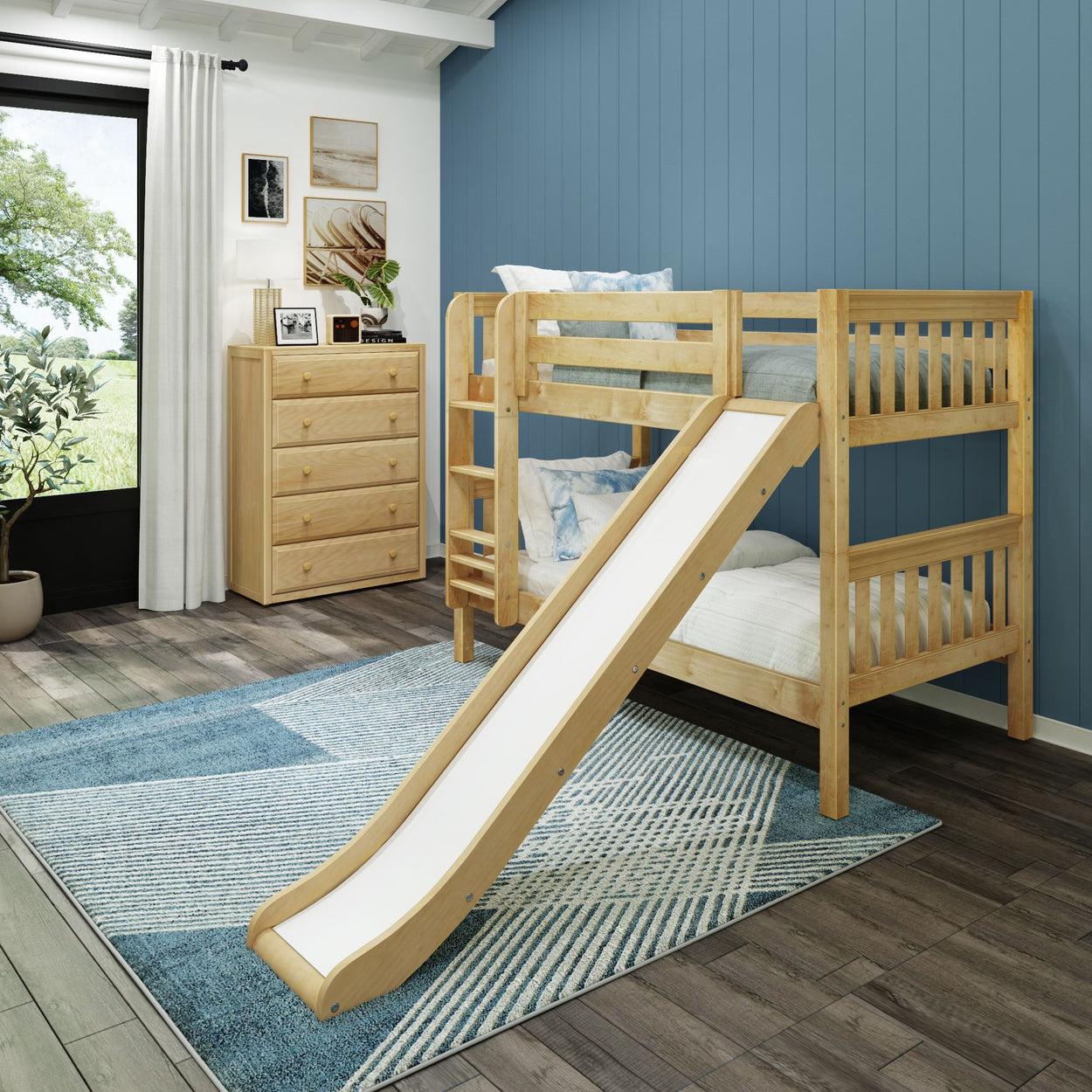 Kid's bedroom with wooden bunk bed and slide, featuring blue accent wall and natural light.
