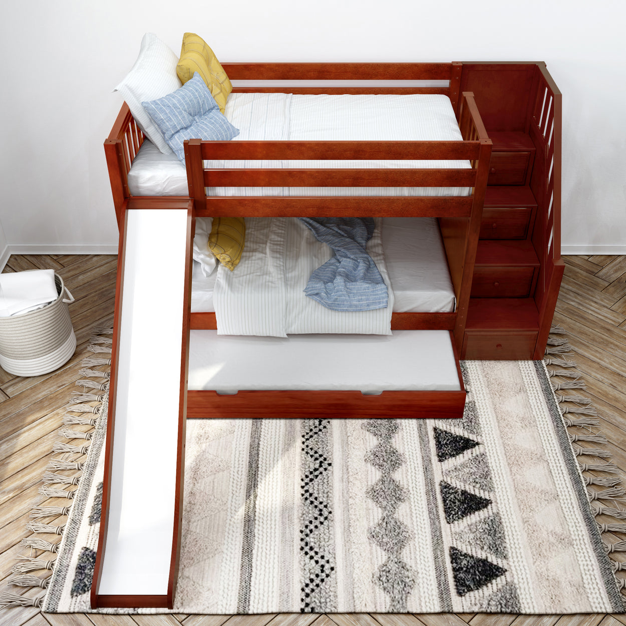 Children’s bunk bed with a slide, wooden staircase, and storage drawers on a stylish rug in a modern bedroom.