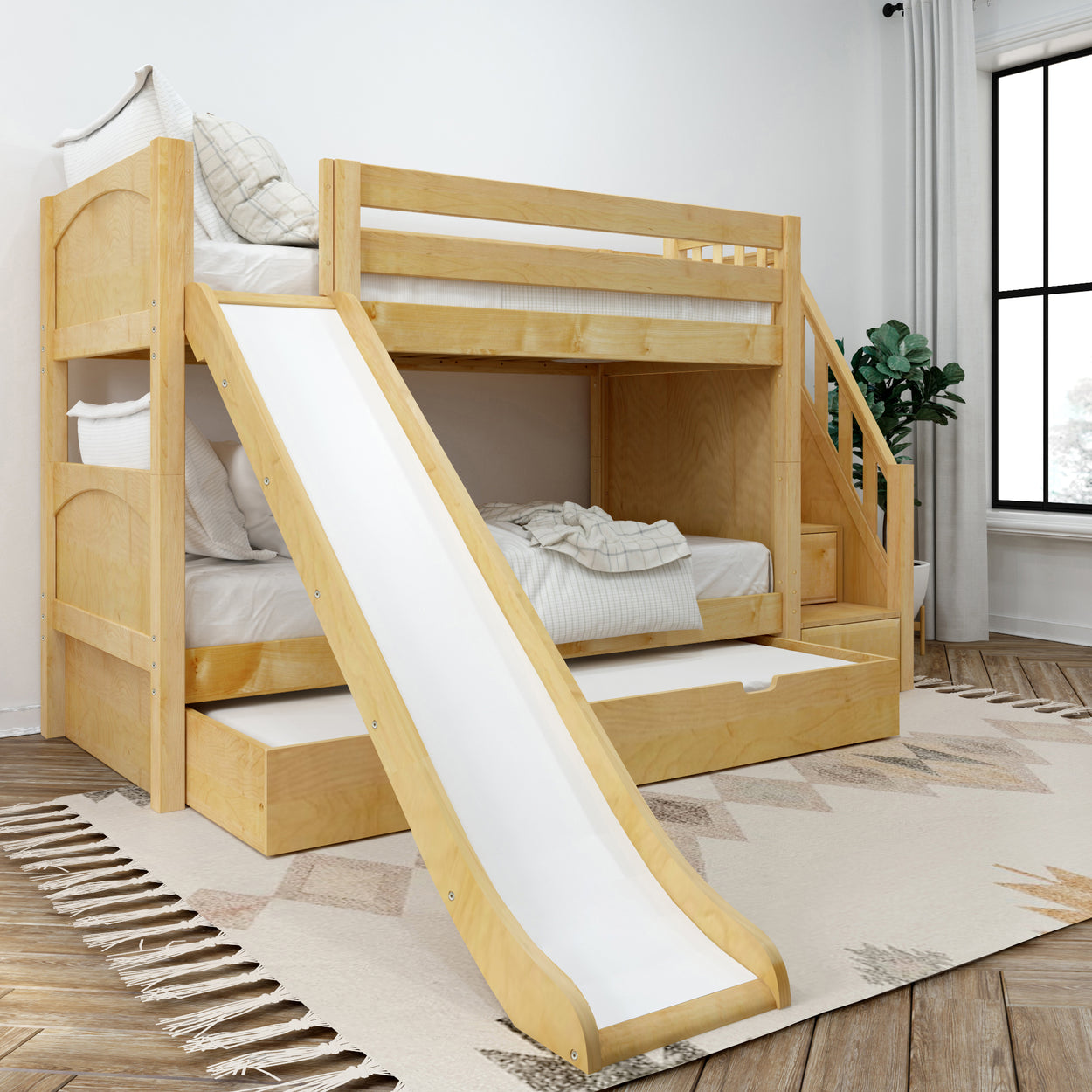 Wooden bunk bed with slide, integrated drawers, and stairs in a cozy kid's bedroom.