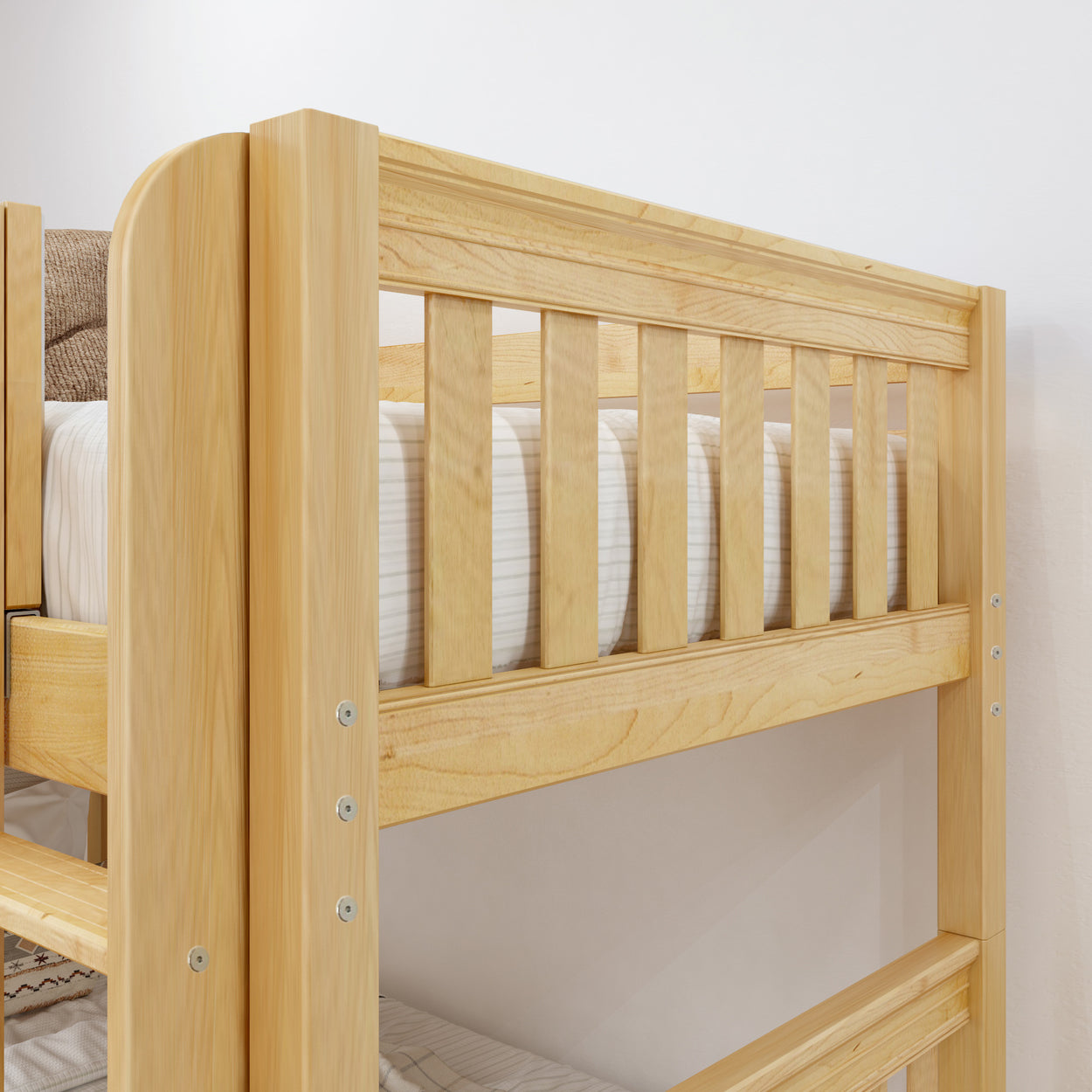 Natural wood bunk bed frame with safety rails in modern bedroom setting.
