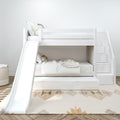 Modern white bunk bed with slide and storage stairs in a children's bedroom.