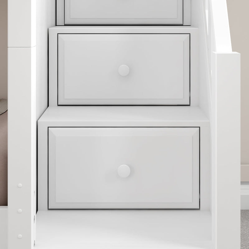 Close-up of white built-in staircase drawers with recessed panel fronts and round knobs, modern under-stair storage solution