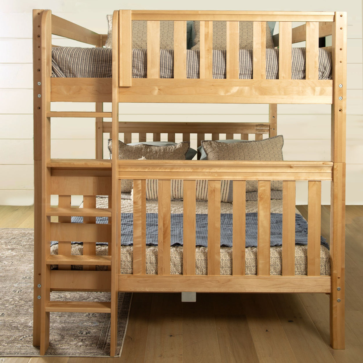 Wooden bunk bed with a ladder and striped bedding in a cozy bedroom setting.