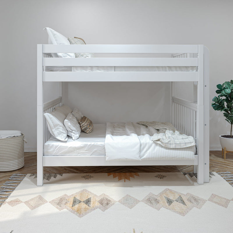 White modern twin-over-twin bunk bed with safety rails, neutral beige bedding and pillows in a minimalist kids' bedroom — space-saving children's room decor with rug and potted plant