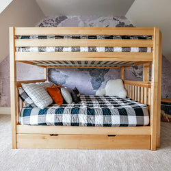 Wooden bunk bed with world map wallpaper and decorative pillows in a kid's bedroom.