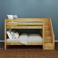 Natural wood bunk bed with staircase and built-in storage drawers, gray and white bedding with pillows against a blue paneled accent wall in a kids' bedroom