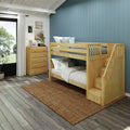 Wooden bunk bed with stairs in bright kids' bedroom with blue vertical accent wall, natural wood dresser, white curtains and woven rug