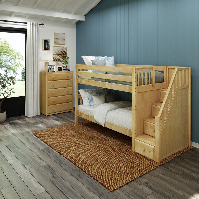 Natural wood bunk bed with stair storage in modern kids' bedroom featuring a blue vertical accent wall, wooden dresser, rug and hardwood floor