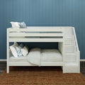 White wooden bunk bed with built‑in staircase drawers, gray bedding and blue decorative pillows against teal shiplap wall in a modern kids bedroom with woven jute rug