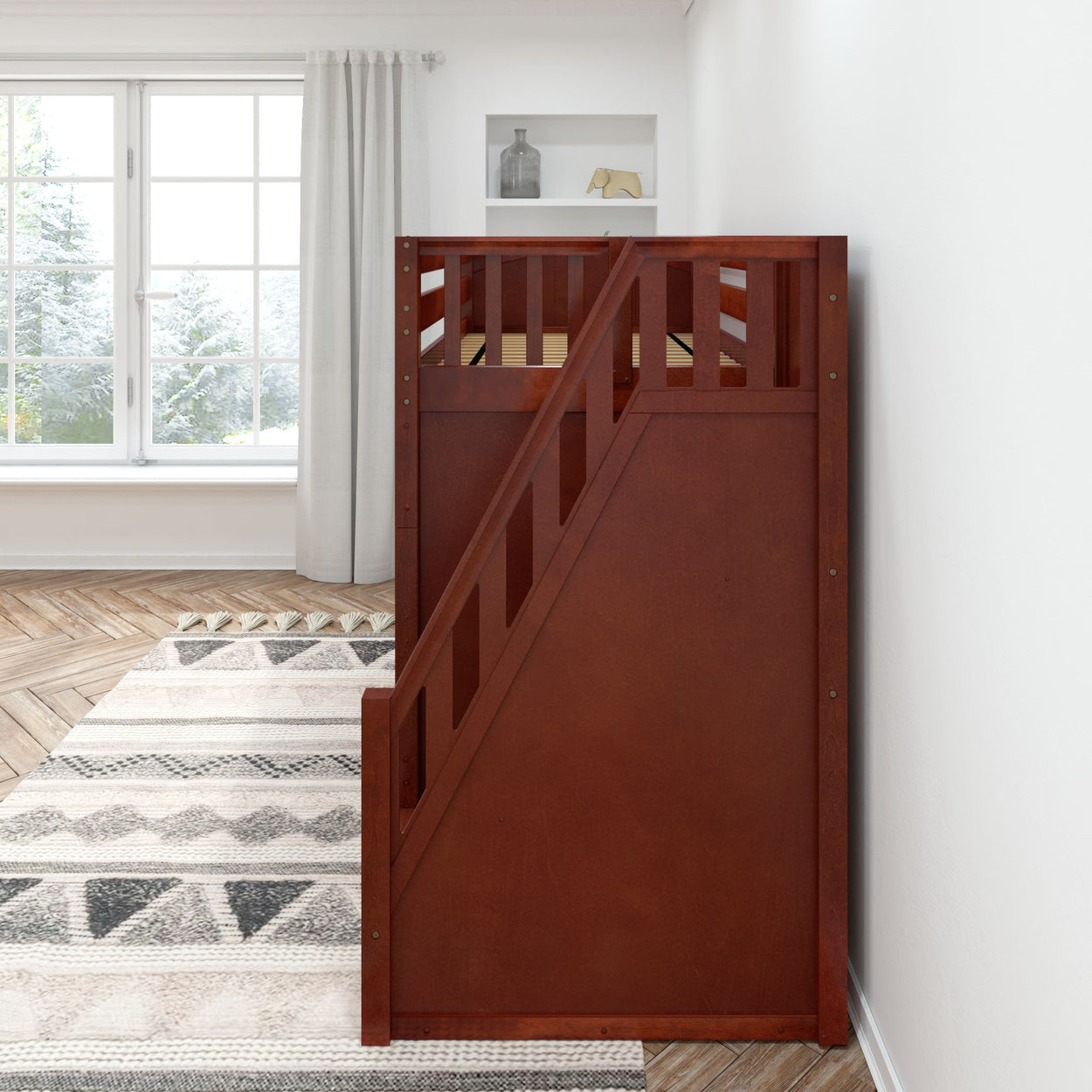 Wooden loft bed with side staircase in a bright cozy bedroom featuring herringbone hardwood floors and a large window.