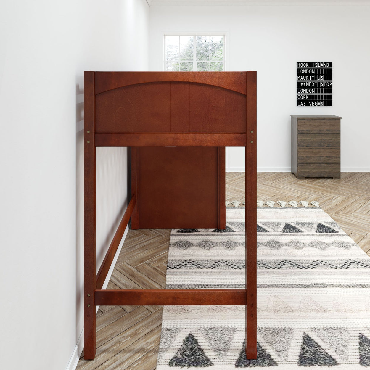 Wooden loft bed in modern bedroom interior with chevron patterned floor and chest of drawers.