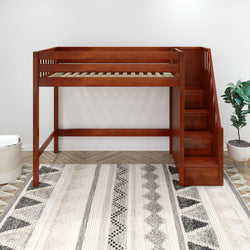 Wooden loft bed with built-in storage stairs in a modern bedroom with patterned rug and potted plant.