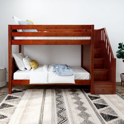 Wooden bunk bed with stairs, featuring white bedding and a modern geometric rug in a cozy bedroom interior.