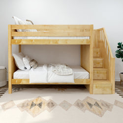 Wooden bunk bed with storage stairs in cozy bedroom setting.