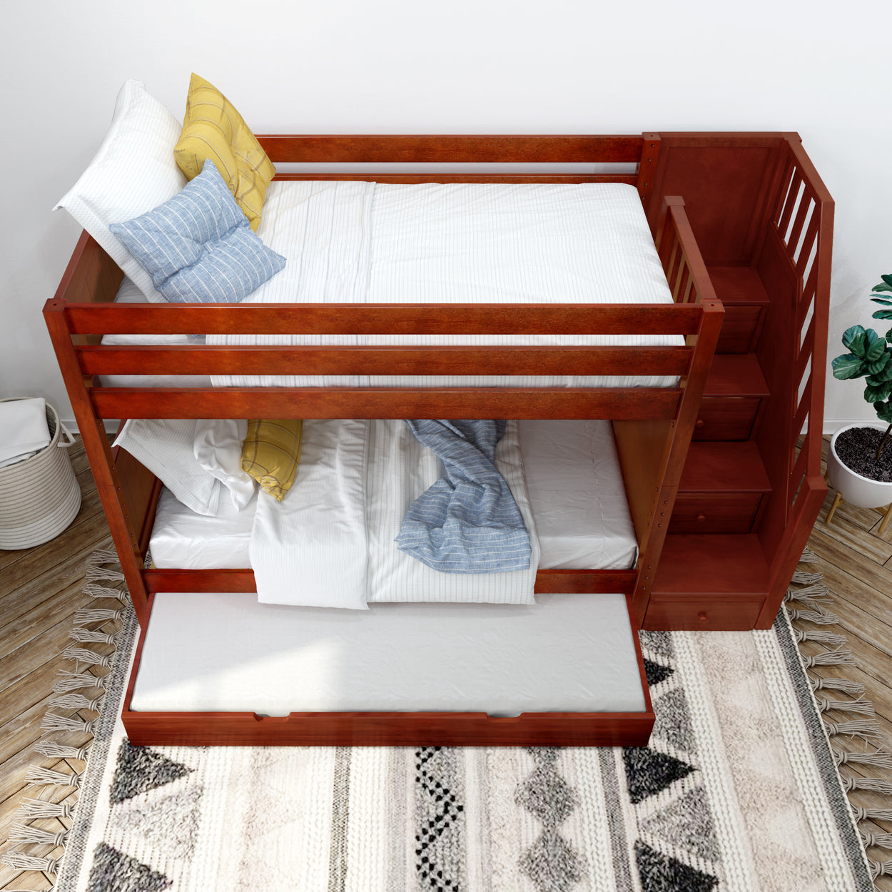 Wooden bunk bed with stairs and trundle, featuring white and blue bedding, in a modern bedroom setting.
