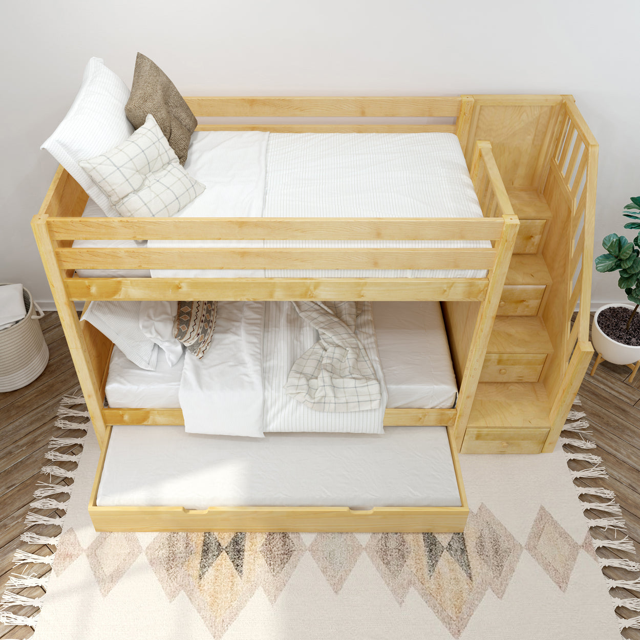 Wooden bunk bed with staircase and trundle drawer in a cozy bedroom setting.