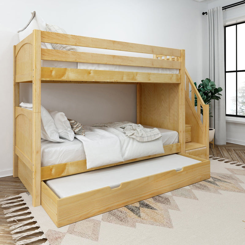 Natural pinewood bunk bed with pull-out trundle and built-in staircase, white bedding in a modern bedroom with patterned rug and potted plant