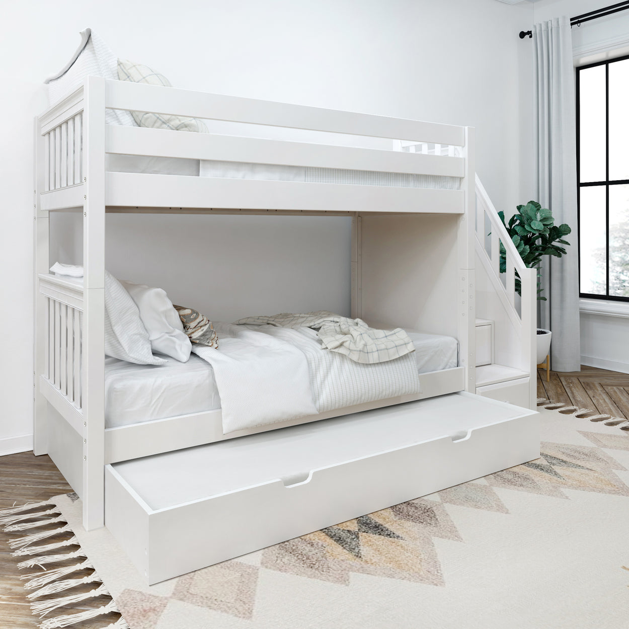White wooden bunk bed with pull-out trundle in modern bedroom setting.