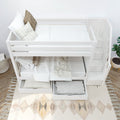 White wooden bunk bed with integrated storage drawers and steps in a cozy bedroom setting.