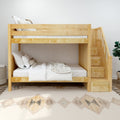 Light wood bunk bed with built-in staircase and storage drawers, neutral linens and pillows on patterned rug in a modern space-saving kids' bedroom