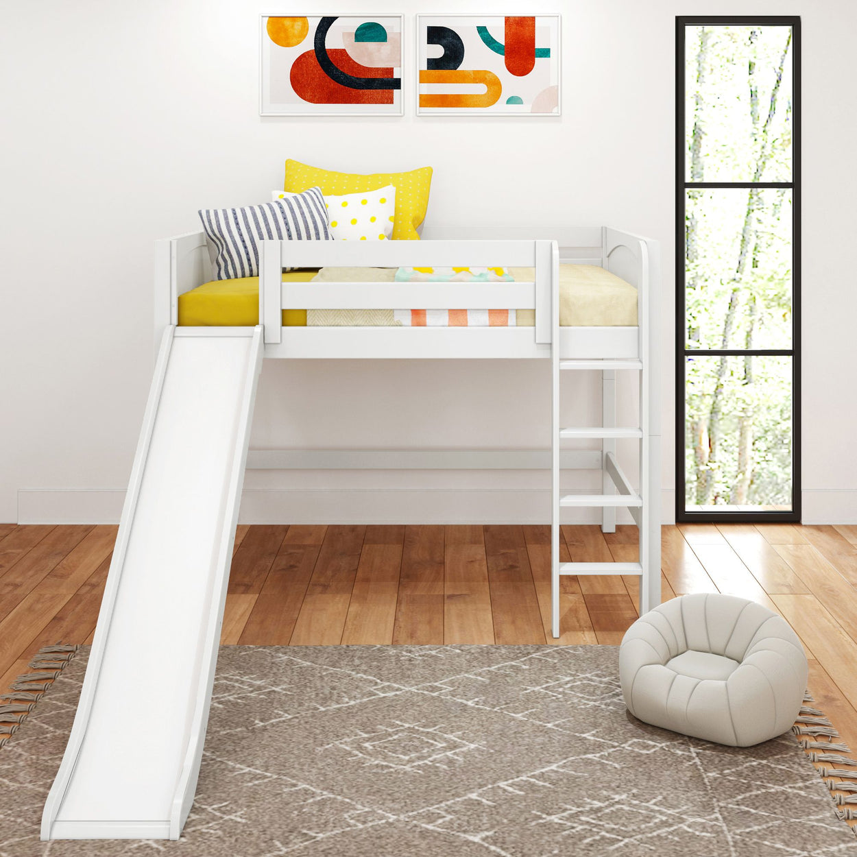 Stylish white loft bed with slide and ladder, featuring vibrant yellow and striped pillows, modern artwork, and a cozy armchair in a bright kids' room.