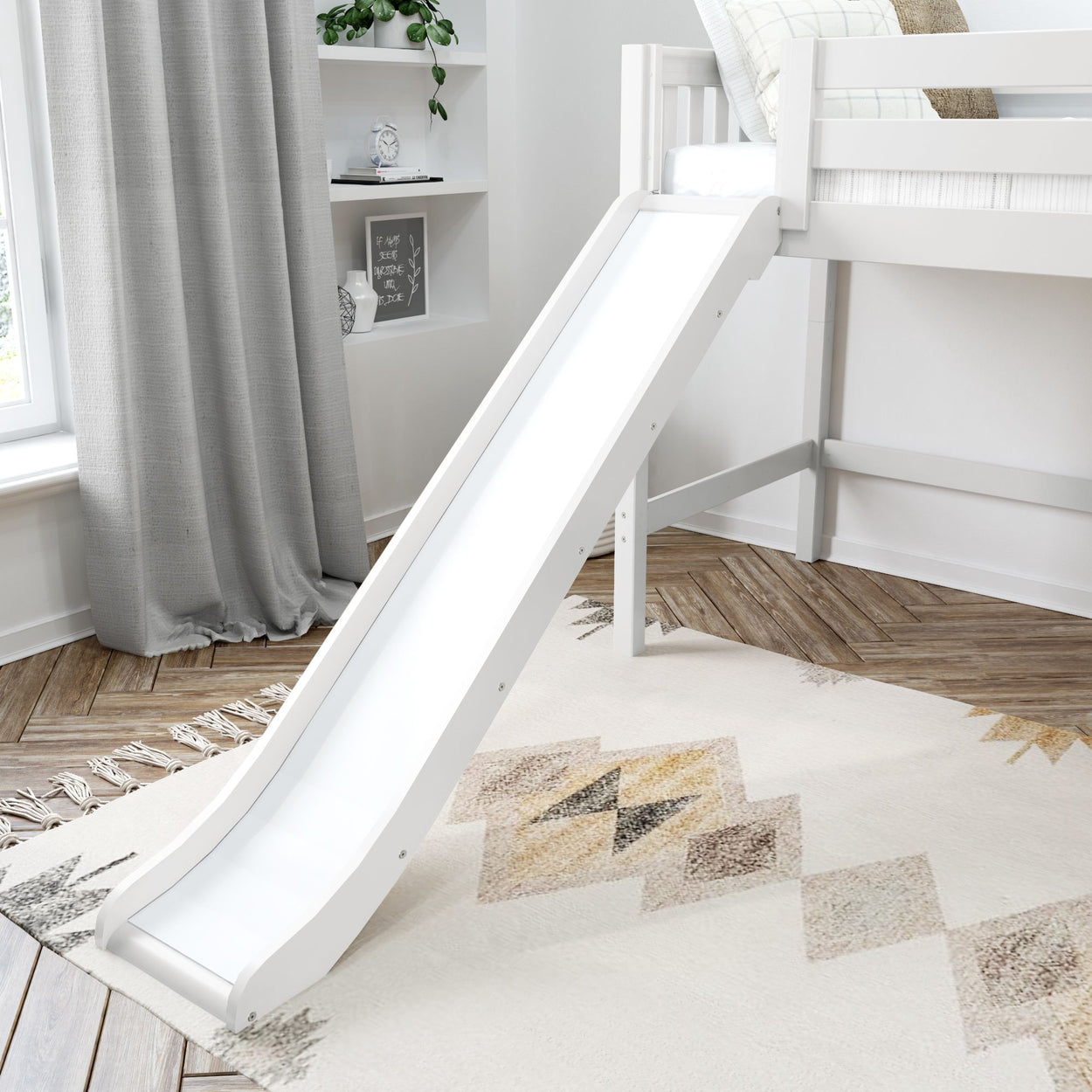 White children's loft bed with slide in a modern bedroom featuring a geometric rug and gray curtains.