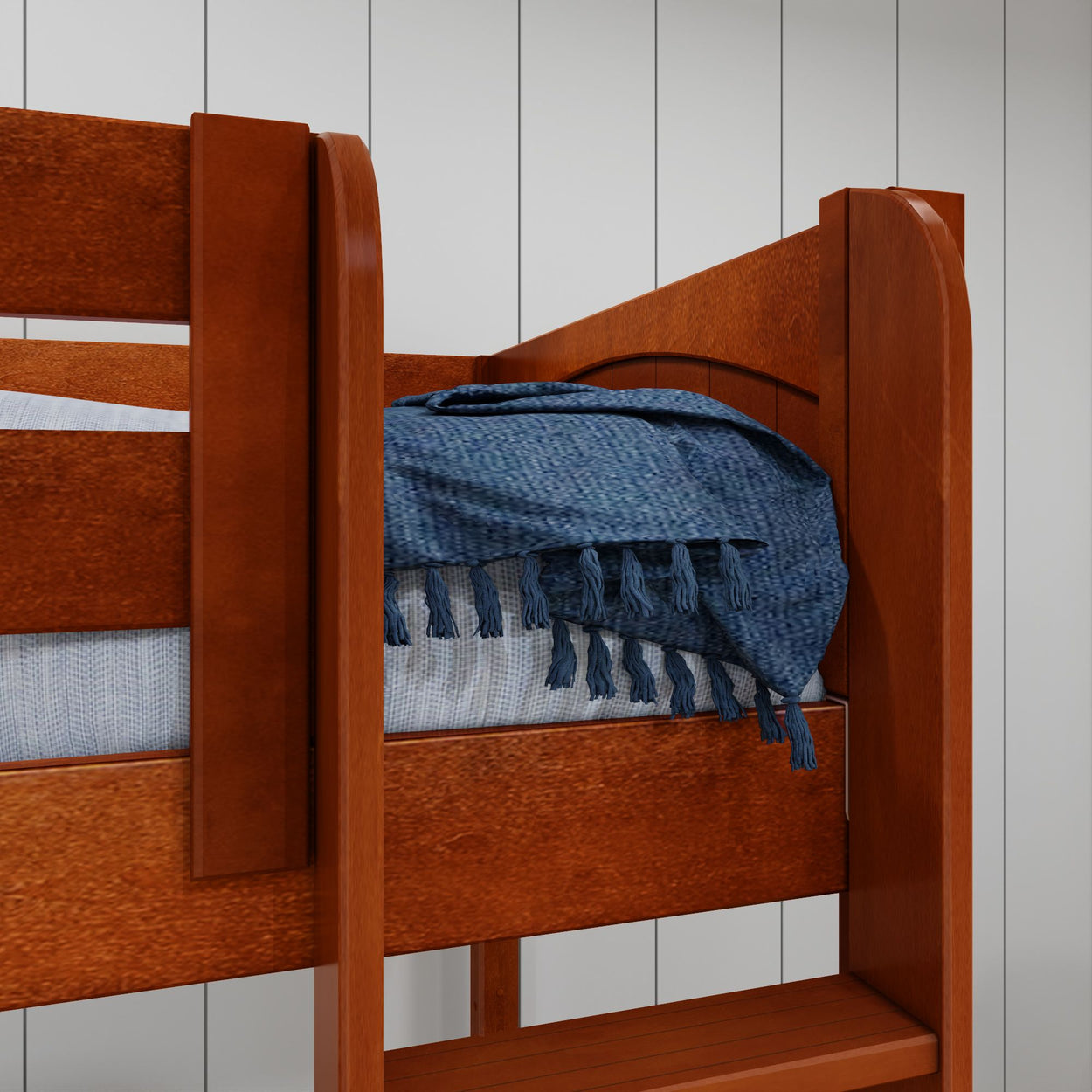 Wooden bunk bed with blue blanket in modern bedroom setting.