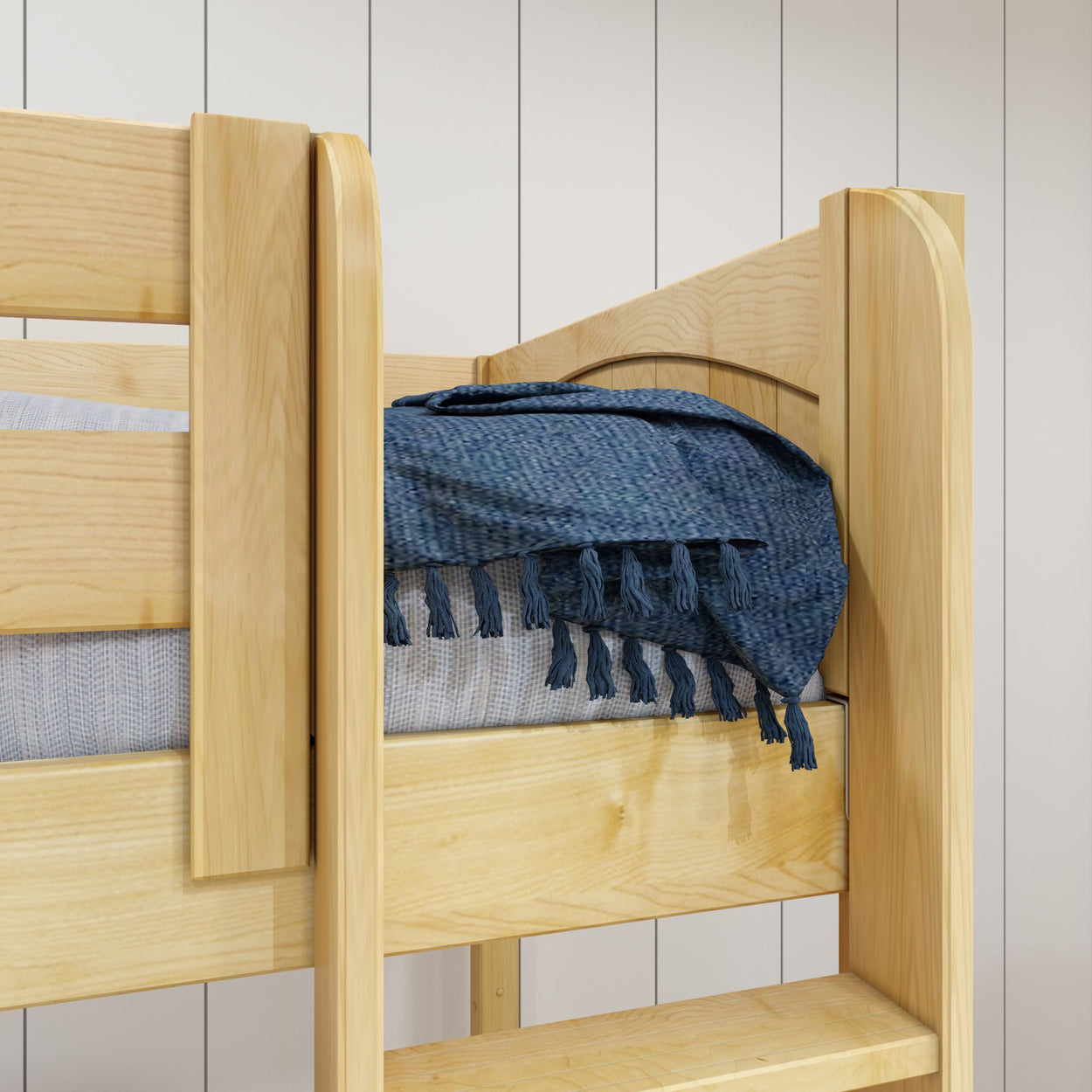 Wooden loft bed with blue blanket in a modern bedroom setting.