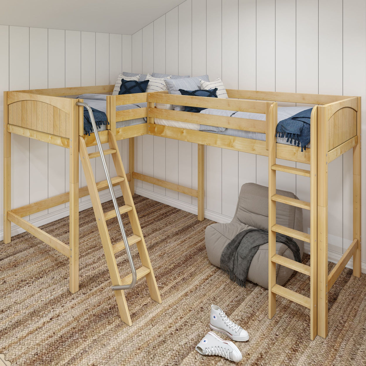 Wooden loft bed with L-shaped design and ladder in cozy bedroom interior with striped bedding and soft rug.