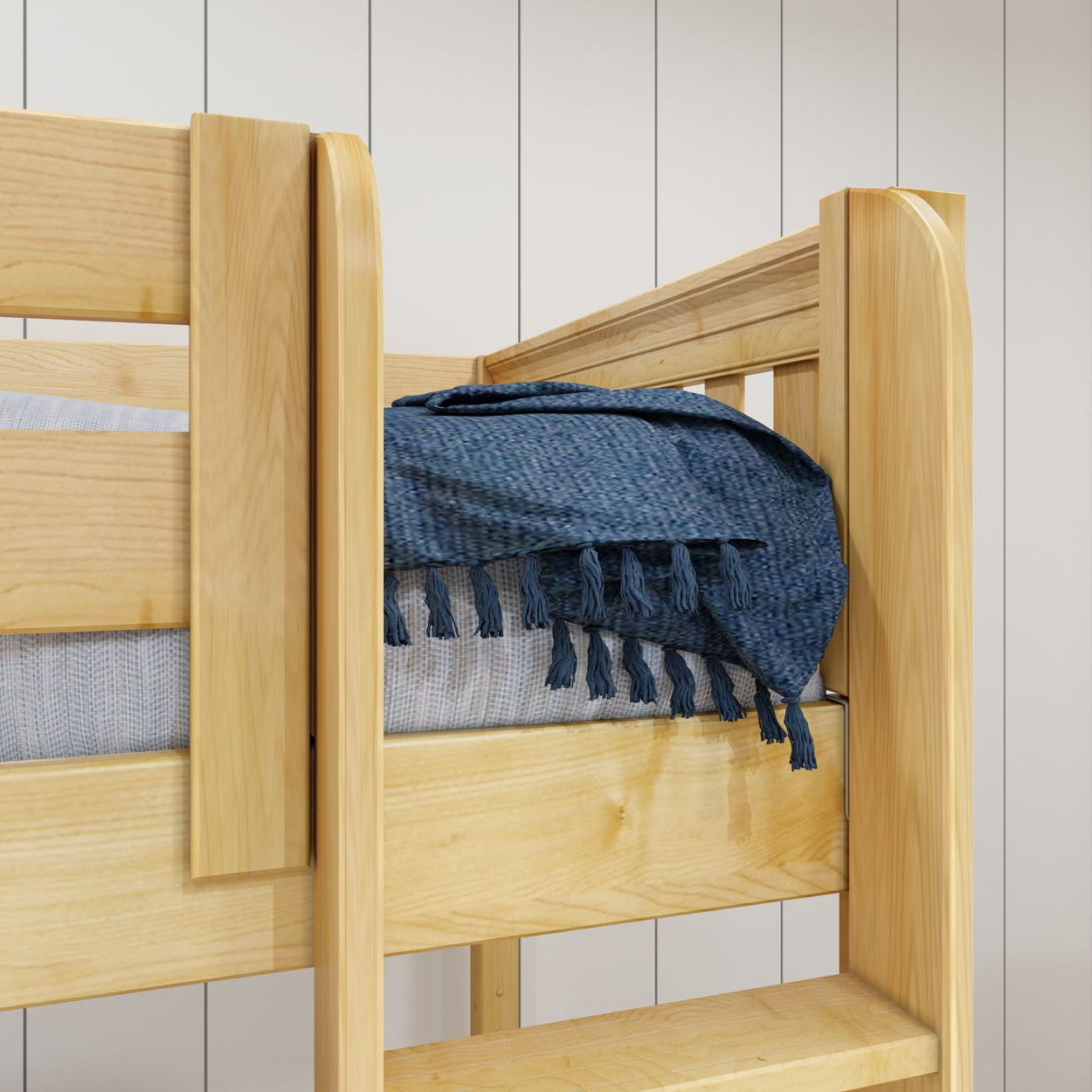 Wooden bunk bed with blue throw blanket in a modern bedroom setting.