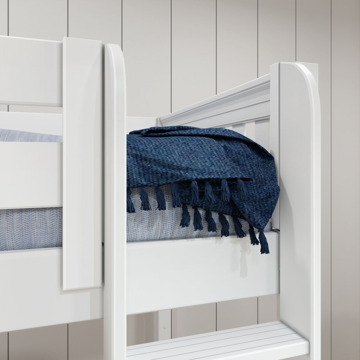 White bunk bed with blue throw blanket in modern bedroom setting.