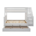 White wooden twin-over-full bunk bed with built-in staircase storage drawers, under-bed trundle drawer, slatted mattress bases, and space-saving kids' bedroom design