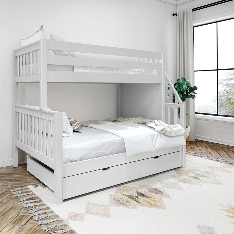 White wooden twin-over-full bunk bed with built-in storage trundle in a bright modern bedroom with white bedding, geometric rug, hardwood floors, large window and potted plant