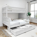 White wooden full-over-full bunk bed with pull-out storage drawer, neutral bedding, ladder stairs, potted plant and large window in a bright modern kids' bedroom on hardwood floor