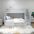 White wooden bunk bed with staircase drawers and under-bed storage in a modern neutral kids' bedroom with white bedding and patterned rug