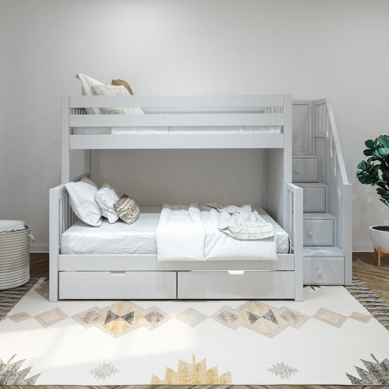 White wooden bunk bed with staircase drawers and under-bed storage in a modern neutral kids' bedroom with white bedding and patterned rug