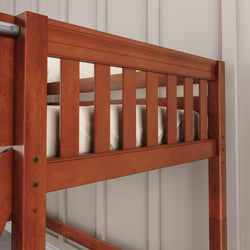 Wooden bunk bed rail detail with beige wall background.