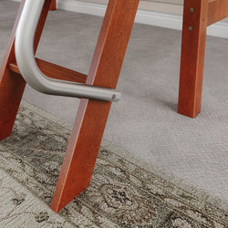 Wooden ladder leg with metal support on carpeted floor and patterned rug.