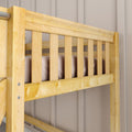 Close-up of solid natural pine bunk bed guardrail and vertical slats with smooth finish against a beige paneled wall