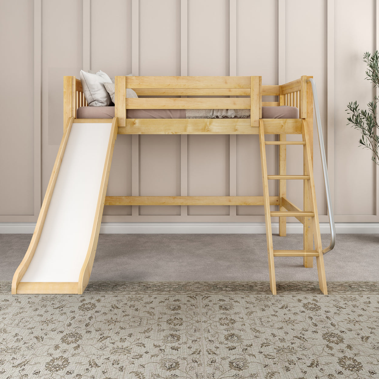 Wooden loft bed with slide and ladder in children’s room, beige wall, and patterned rug.